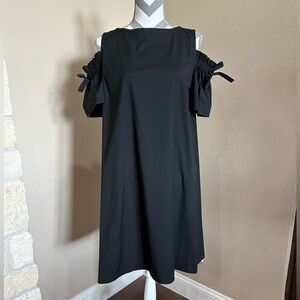 Black dress with open shoulders and ties on upper arm
